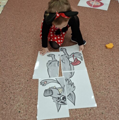 dzieci układają duże puzzle z postaciami z bajek