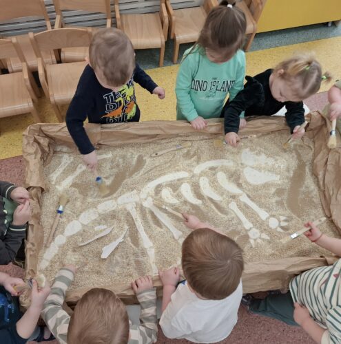 dzieci odkopują zakopane kości dinozaura zrobione z masy solnej