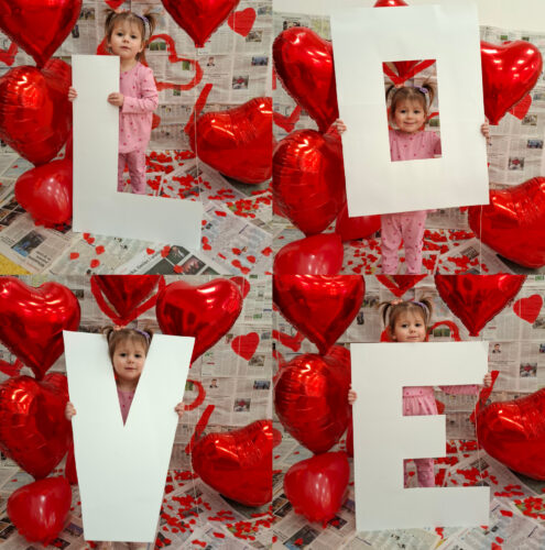 dziecko trzyma napis love